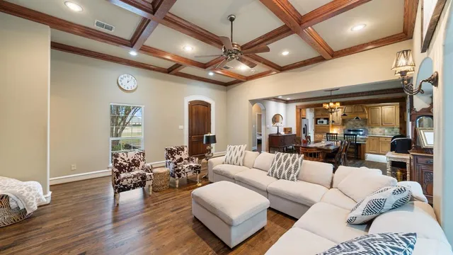 a living room with furniture a table and a large window