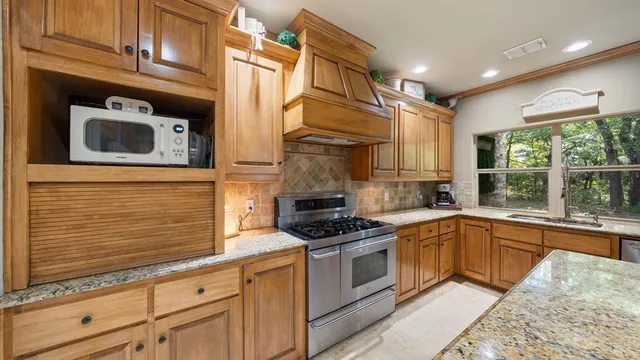 a kitchen with granite countertop a sink and a window