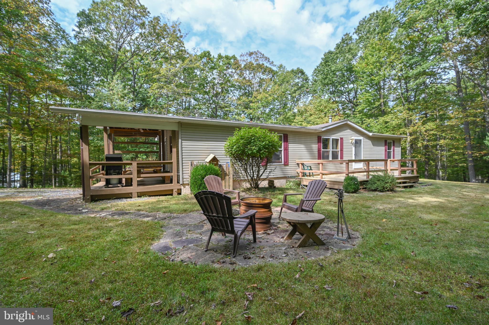 a view of a house with backyard sitting area and garden