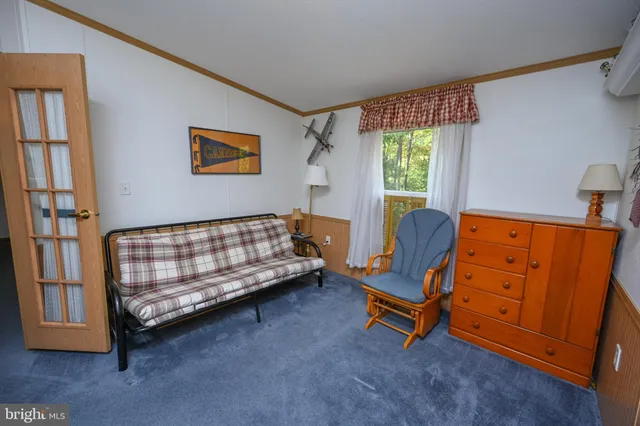 a bedroom with furniture and a window