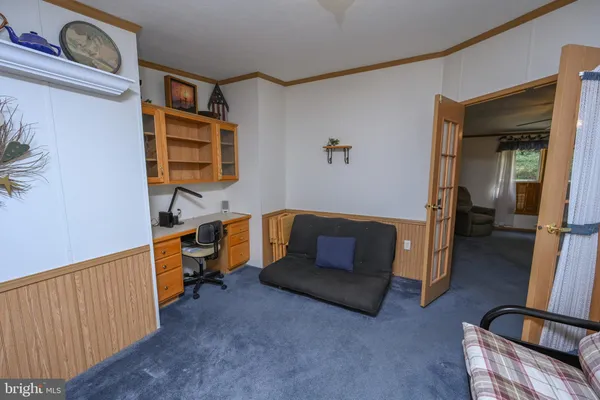 a view of a livingroom with a fireplace and workspace