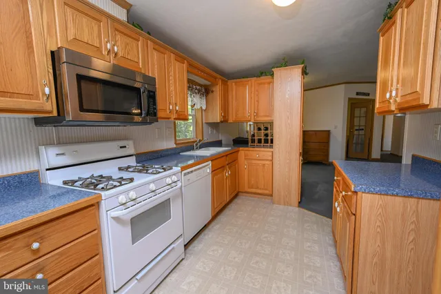 a kitchen with stainless steel appliances a stove sink and microwave