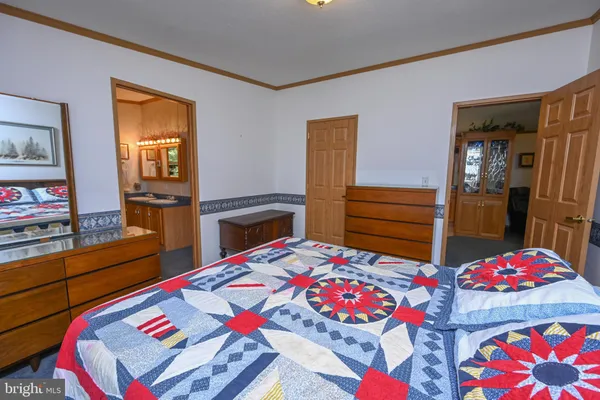 a bathroom with a granite countertop tub sink and mirror