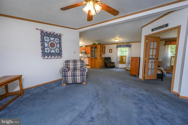 a bathroom with a granite countertop sink toilet a mirror and shower