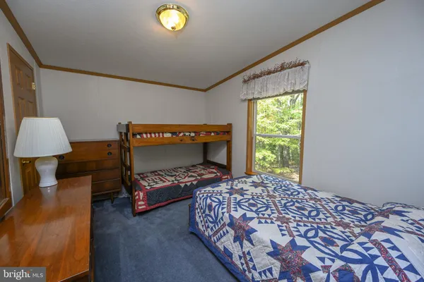 a bed room with a bed and a window