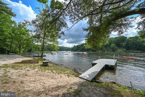 an aerial view of a house with a yard and lake view