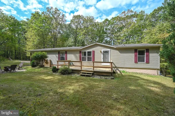 a white house that has a tree in front of it