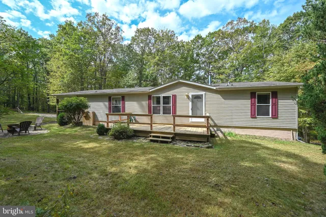 a white house that has a tree in front of it