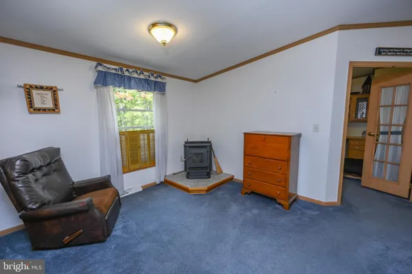 a living room with furniture gym equipment and a window