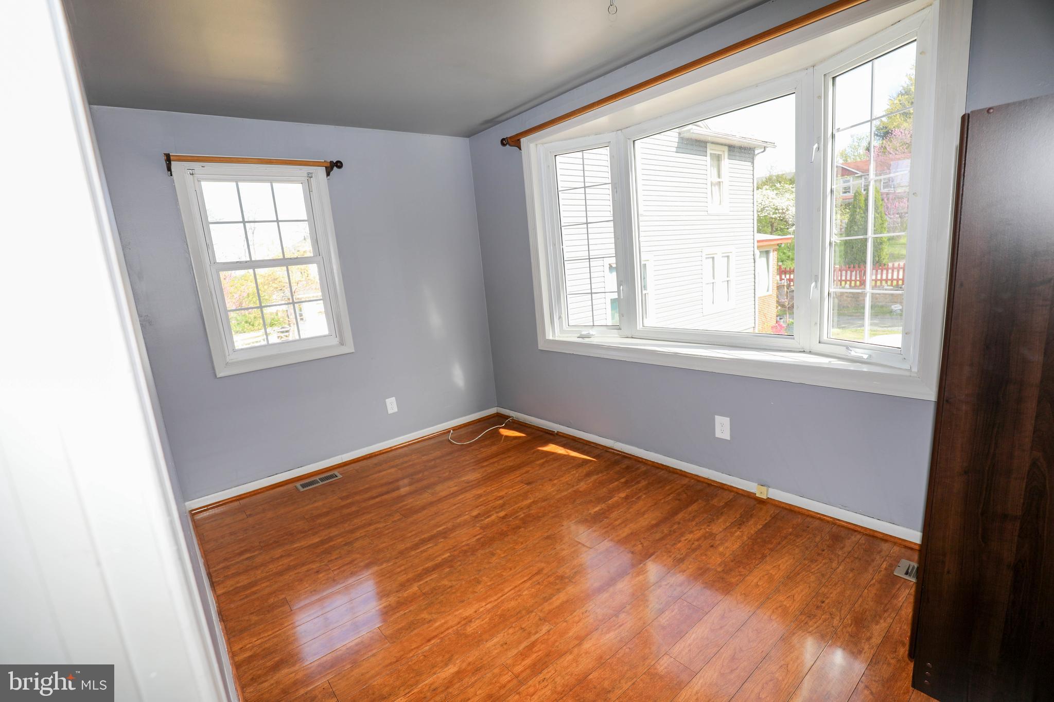 103 R Waelchli Avenue Halethorpe, MD 21227 - Photo 29 of 37 an empty room with wooden floor and windows
