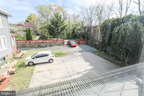 a view of a big house with a big yard and large tree