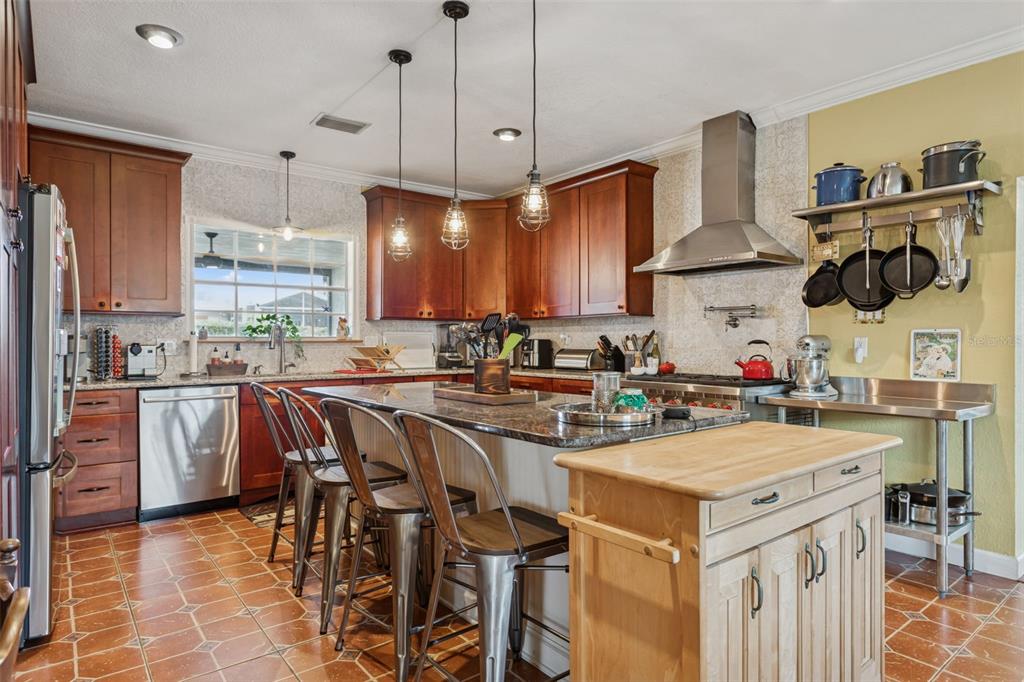 2603 North Ridgewood Avenue Tampa, FL 33602 - Photo 12 of 44 a kitchen with a sink a stove and chairs