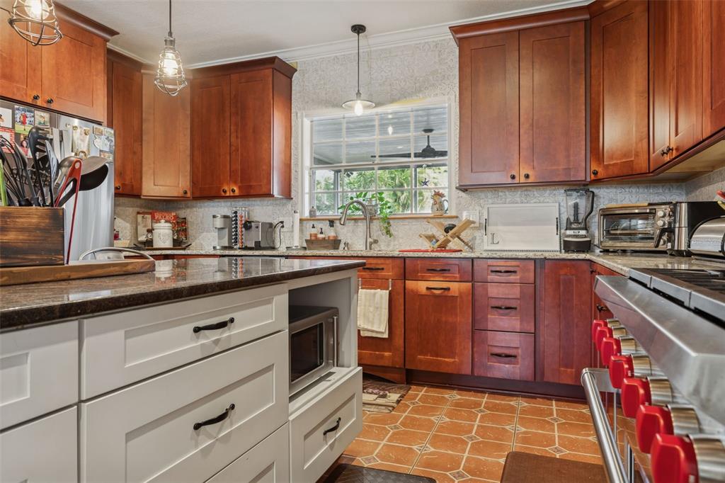 2603 North Ridgewood Avenue Tampa, FL 33602 - Photo 13 of 44 a kitchen with stainless steel appliances granite countertop a sink a stove a oven a counter space and cabinets