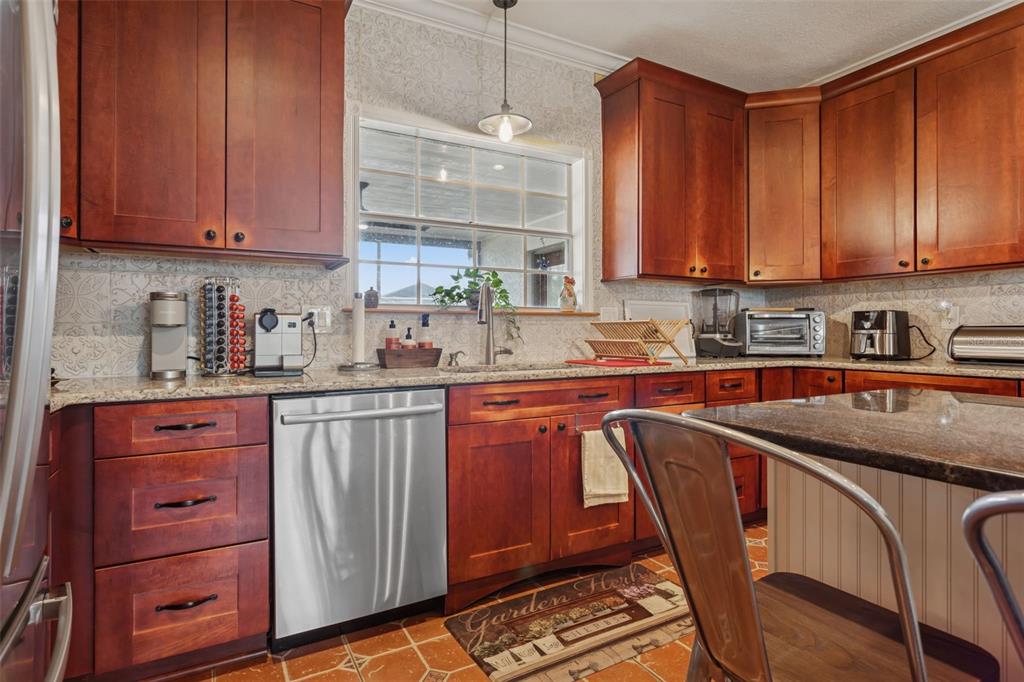 2603 North Ridgewood Avenue Tampa, FL 33602 - Photo 14 of 44 a kitchen with stainless steel appliances granite countertop wooden cabinets a sink and dishwasher