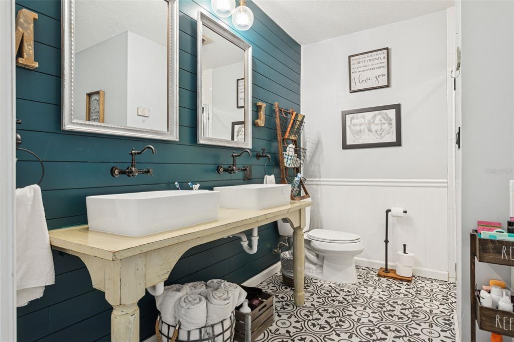 2603 North Ridgewood Avenue Tampa, FL 33602 - Photo 21 of 44 a white toilet sitting next to a bathroom sink