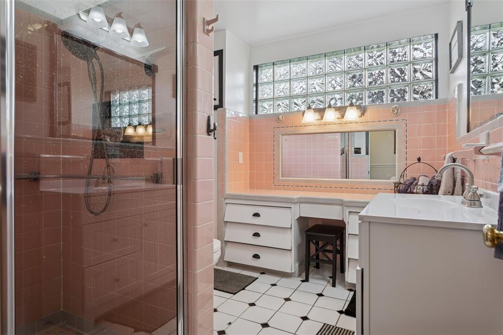 2603 North Ridgewood Avenue Tampa, FL 33602 - Photo 25 of 44 a spacious bathroom with a granite countertop sink a mirror and shower