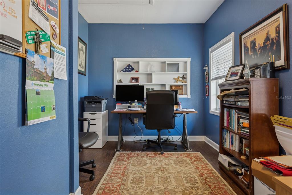 2603 North Ridgewood Avenue Tampa, FL 33602 - Photo 28 of 44 a view of a workspace with furniture and a bookshelf