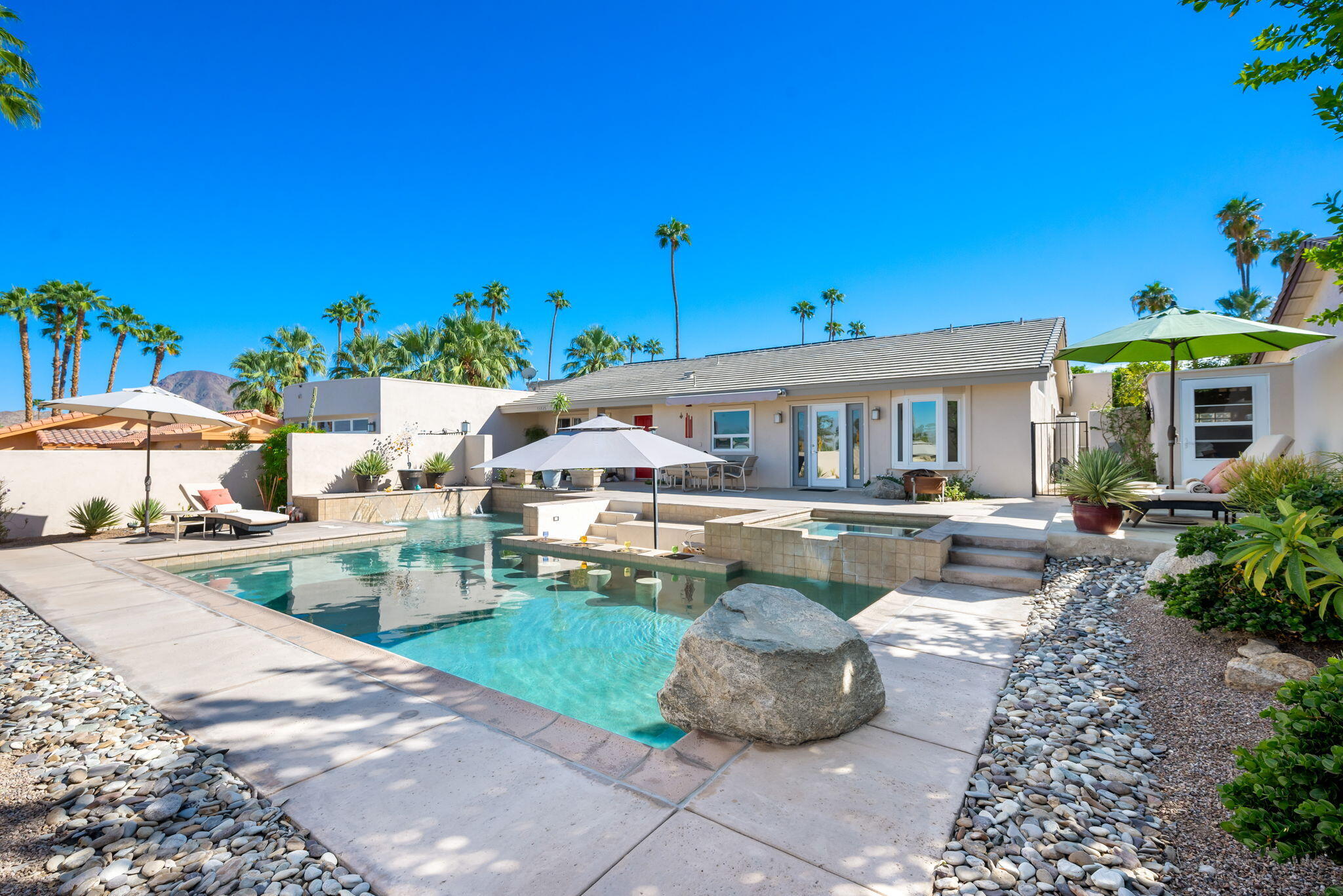 73535 Haystack Road Palm Desert, CA 92260 - Photo 13 of 47 a front view of a house with swimming pool having outdoor seating