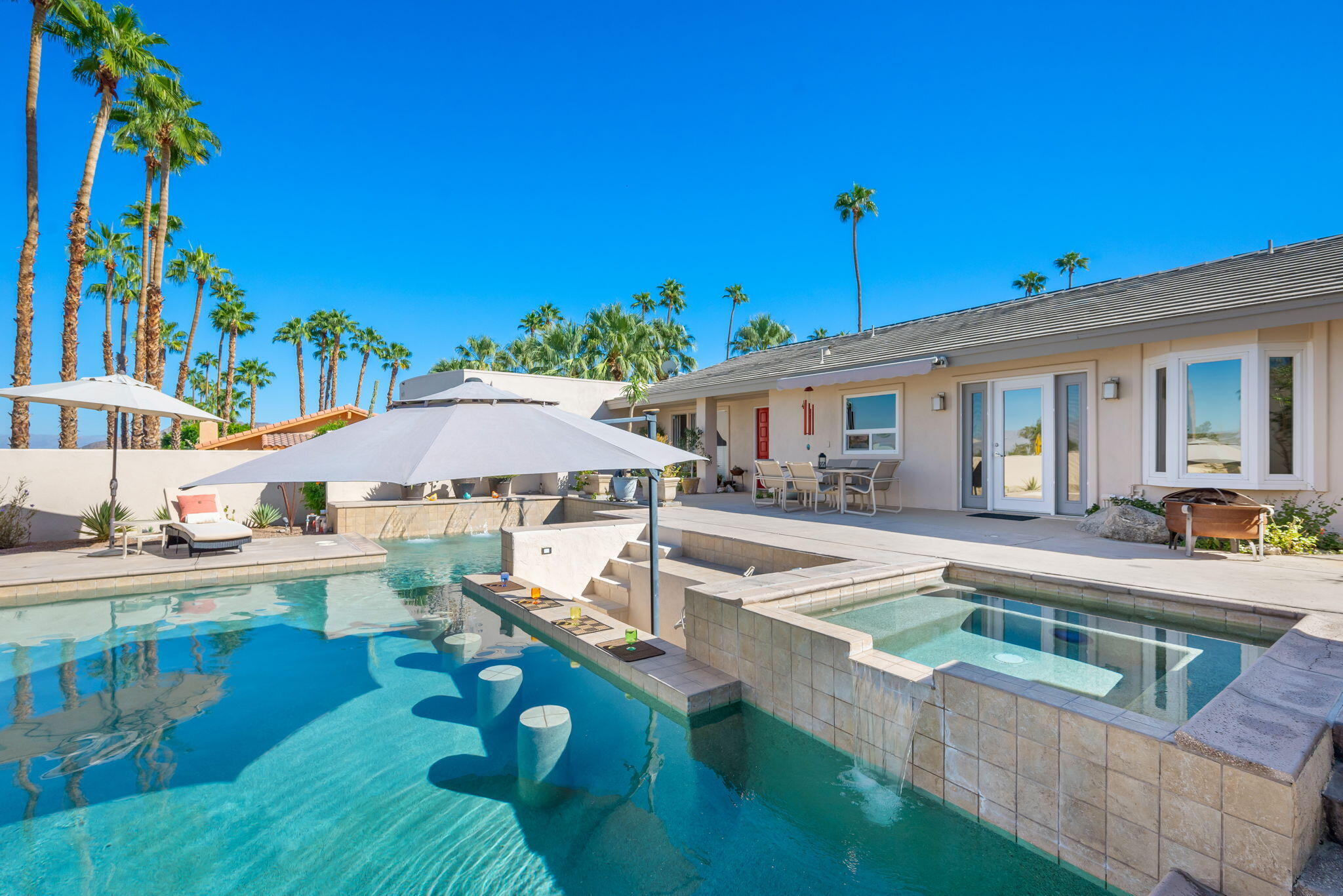 73535 Haystack Road Palm Desert, CA 92260 - Photo 15 of 47 a view of a house with swimming pool and sitting area