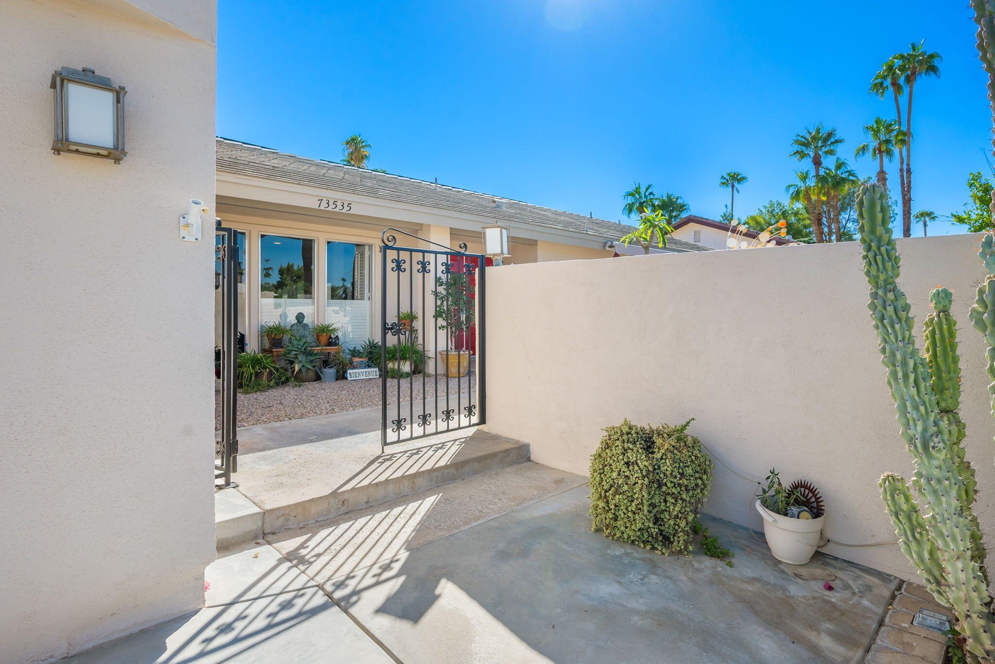 73535 Haystack Road Palm Desert, CA 92260 - Photo 16 of 47 a view of a porch with potted plants