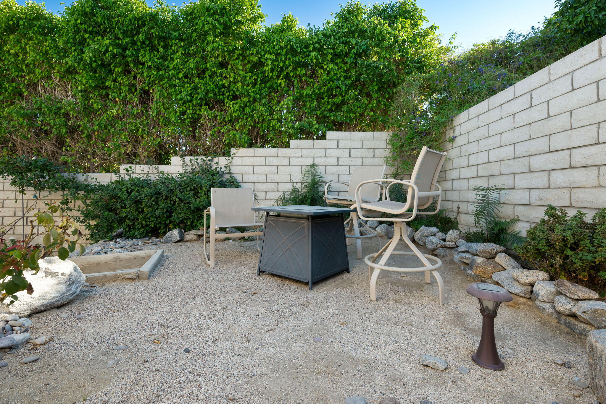 73535 Haystack Road Palm Desert, CA 92260 - Photo 35 of 47 a view of a patio with a table and chairs and a grill