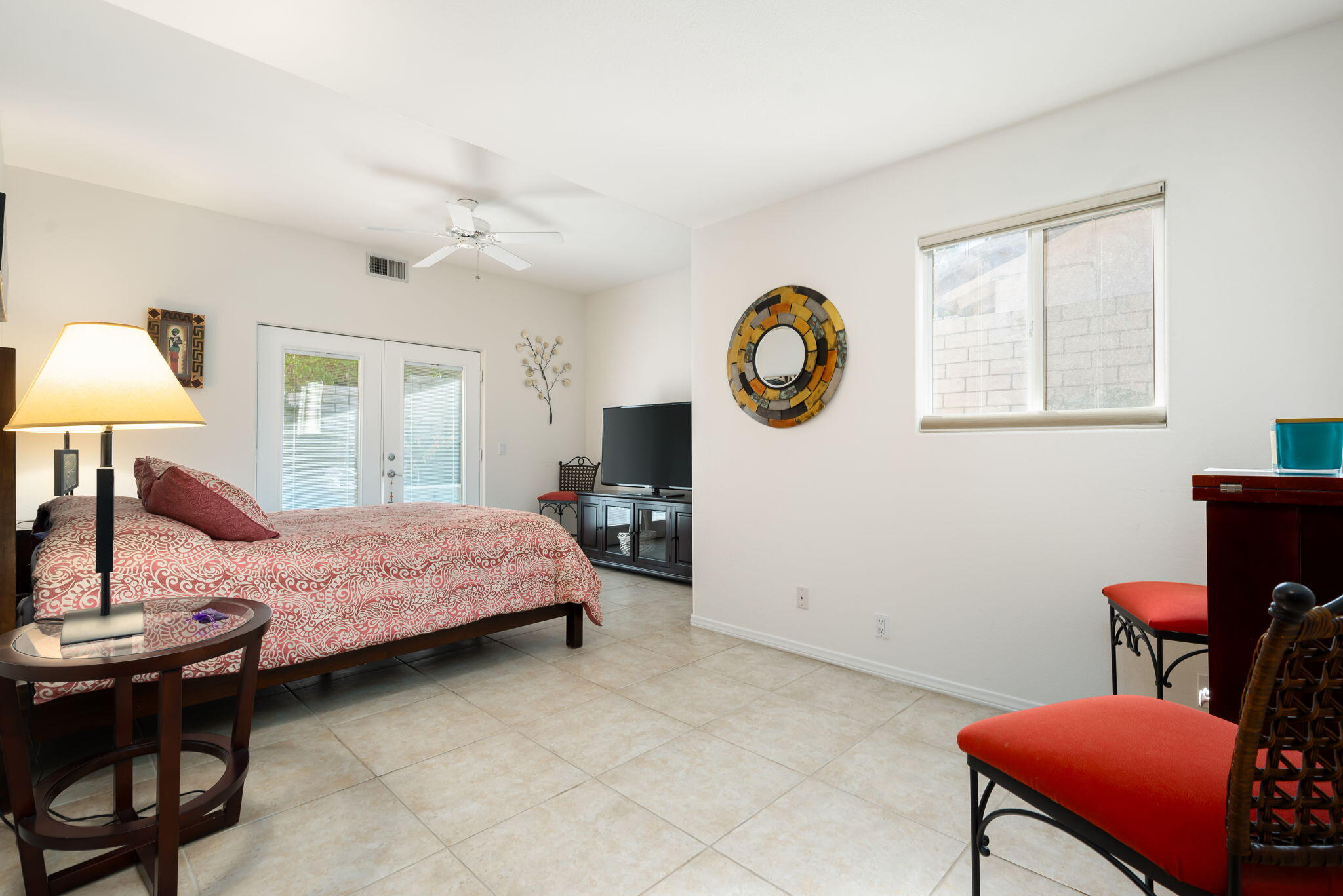 73535 Haystack Road Palm Desert, CA 92260 - Photo 38 of 47 a bedroom with a bed a chair and a chandelier