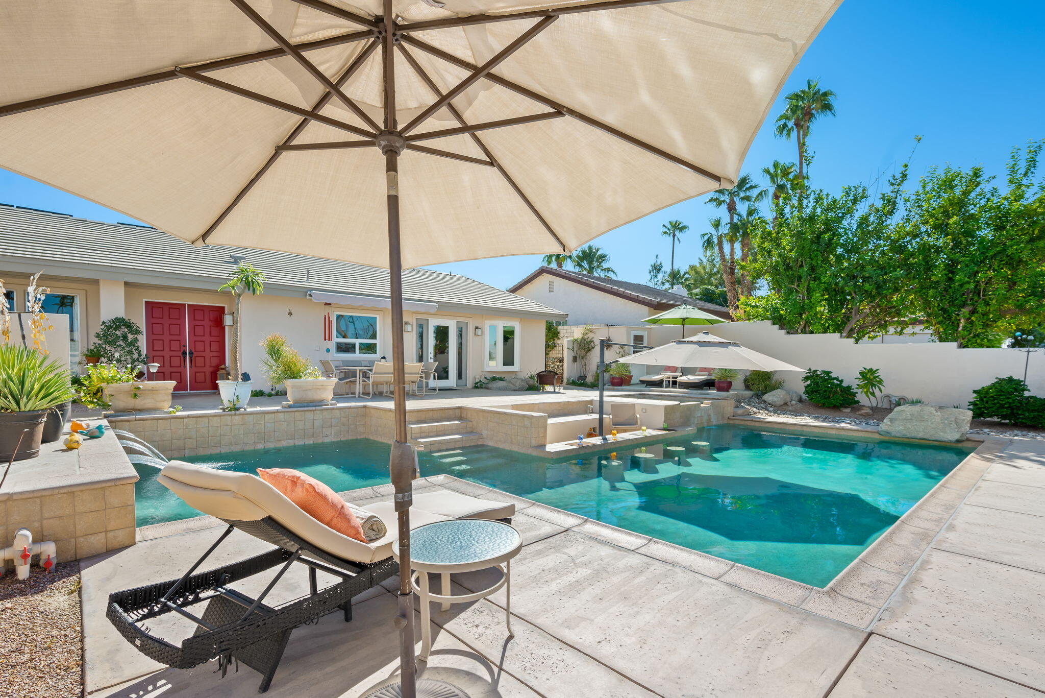 73535 Haystack Road Palm Desert, CA 92260 - Photo 5 of 47 a patio with a table and chairs under an umbrella