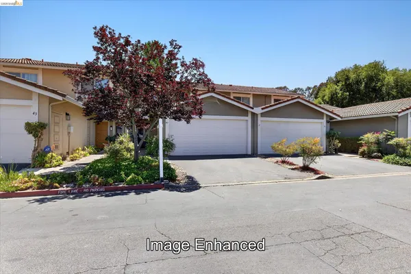 a front view of a house with a yard and a garage