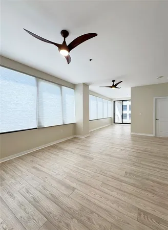 a view of an empty room with wooden floor