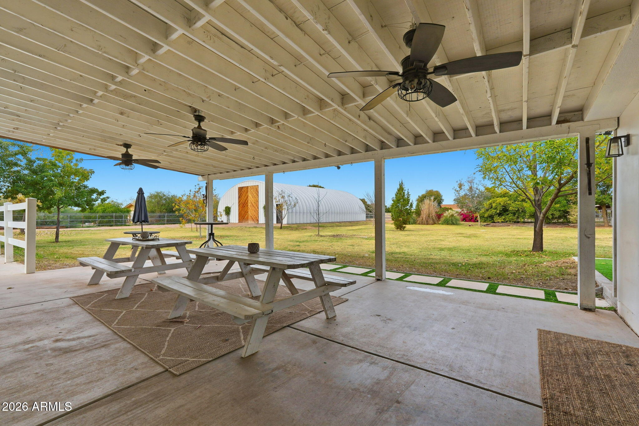 2858 East Redfield Road Gilbert, AZ 85234 - Photo 56 of 60 a view of a patio with a table and chairs under an umbrella