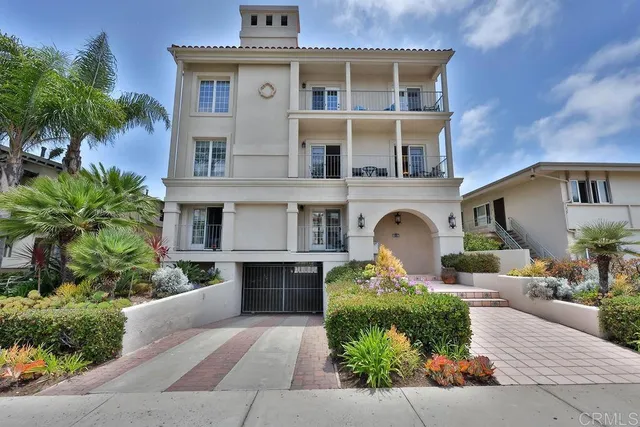 a front view of a house with yard and parking