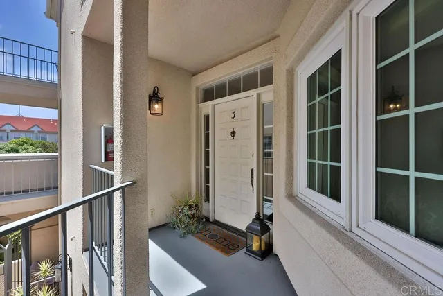 a view of a balcony with wooden floor and front door