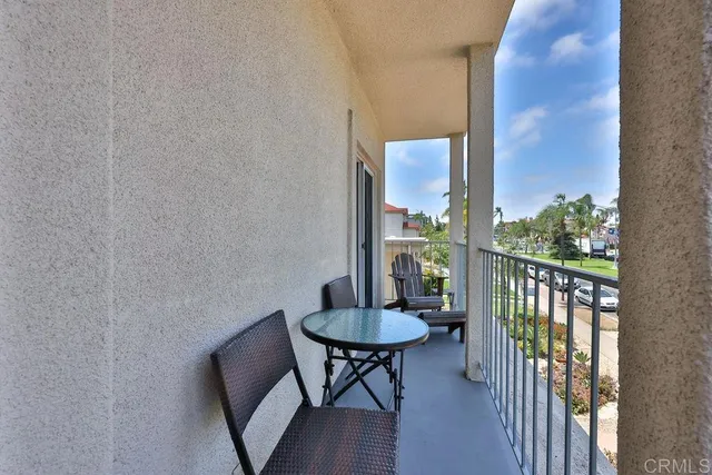 a view of a patio with table and chairs and floor to ceiling window