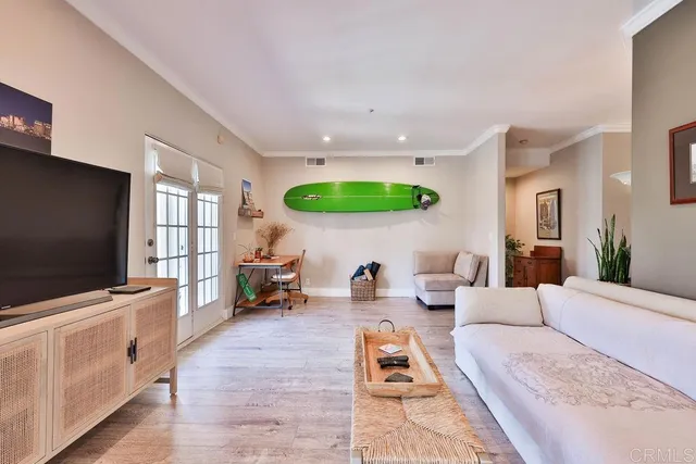 a front view of a house with a garden and potted plants