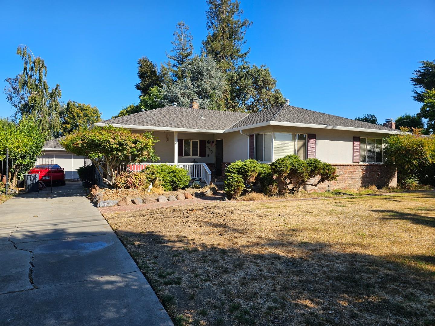 a view of a house with yard and sitting area