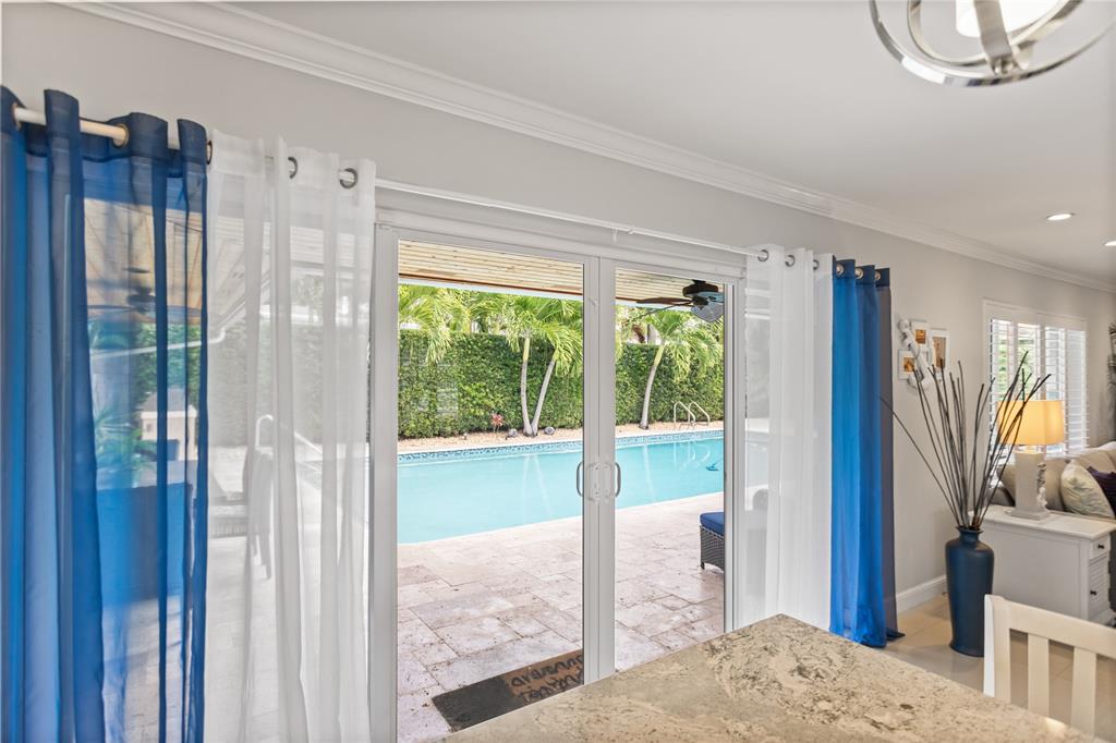 1650 Northeast 27th Avenue Pompano Beach, FL 33062 - Photo 22 of 90 a living room with furniture a floor to ceiling window and wooden floor