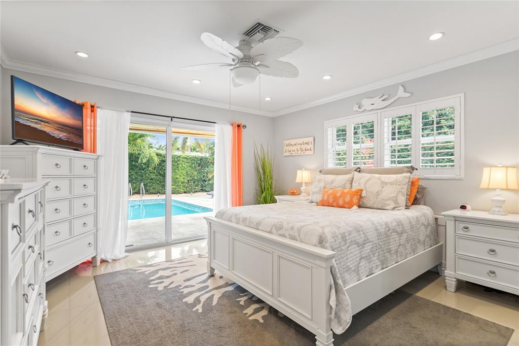 1650 Northeast 27th Avenue Pompano Beach, FL 33062 - Photo 23 of 90 a bedroom with a large bed and a flat tv screen on dresser