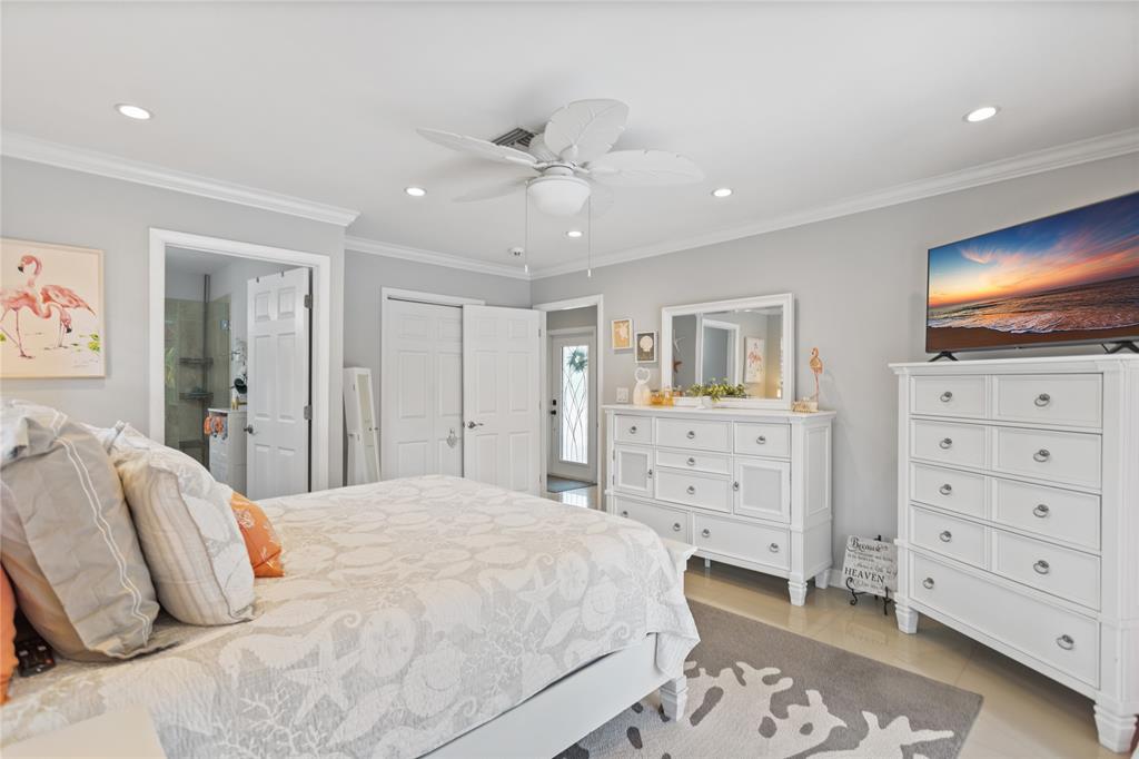 1650 Northeast 27th Avenue Pompano Beach, FL 33062 - Photo 26 of 90 a bedroom with a bed and a flat screen tv