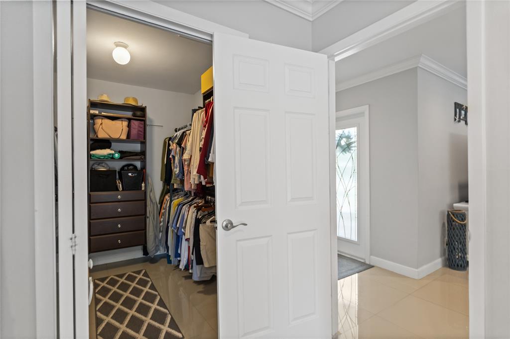 1650 Northeast 27th Avenue Pompano Beach, FL 33062 - Photo 33 of 90 a view of walk in closet with clothes