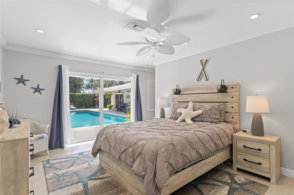 1650 Northeast 27th Avenue Pompano Beach, FL 33062 - Photo 34 of 90 a bedroom with a bed and a chandelier