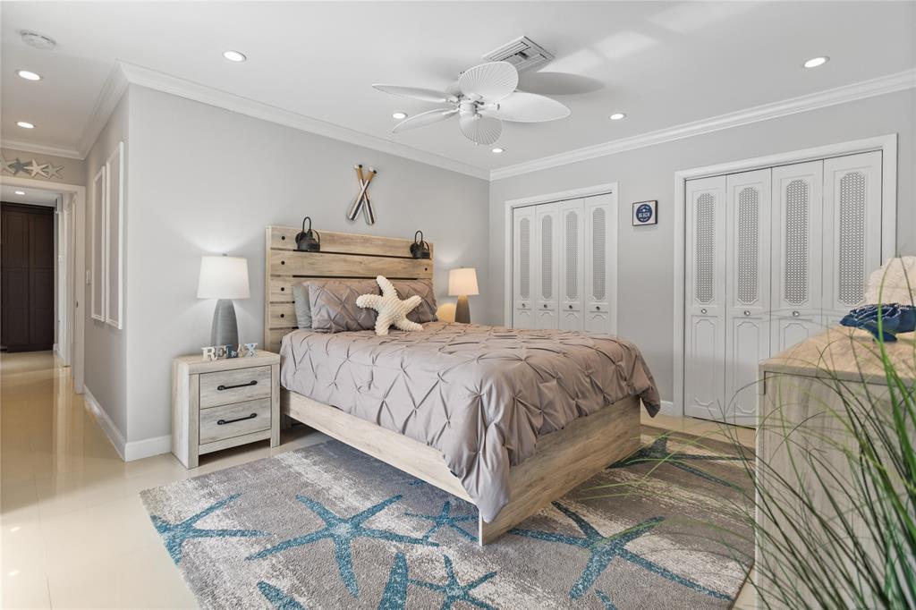 1650 Northeast 27th Avenue Pompano Beach, FL 33062 - Photo 35 of 90 a bedroom with a large bed and ceiling fan