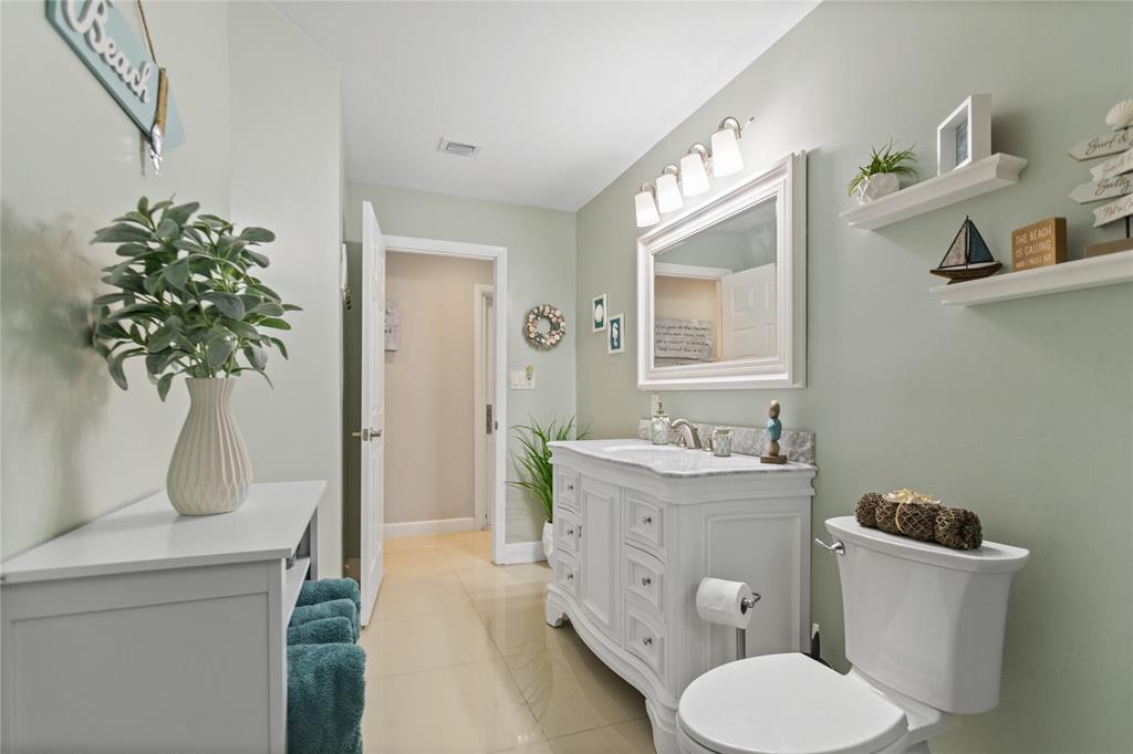 1650 Northeast 27th Avenue Pompano Beach, FL 33062 - Photo 39 of 90 a bathroom with a toilet sink and mirror