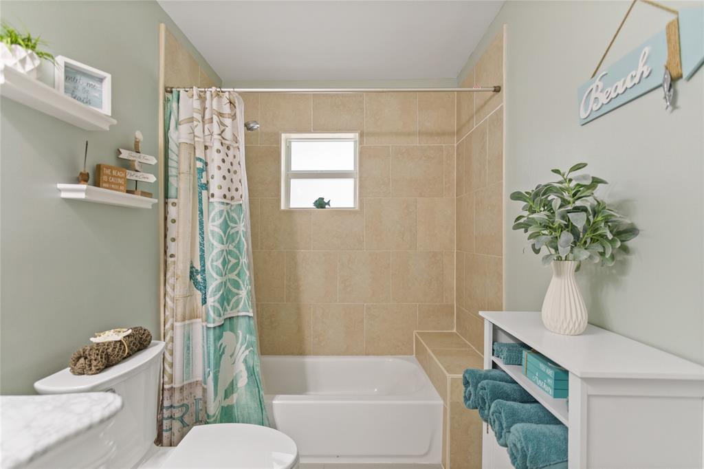 1650 Northeast 27th Avenue Pompano Beach, FL 33062 - Photo 40 of 90 a bath room with a toilet a sink and a bath tub