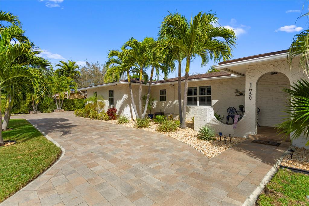 1650 Northeast 27th Avenue Pompano Beach, FL 33062 - Photo 4 of 90 a front view of a house with garden