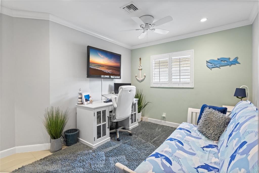 1650 Northeast 27th Avenue Pompano Beach, FL 33062 - Photo 43 of 90 a living room with furniture a chandelier and a flat screen tv