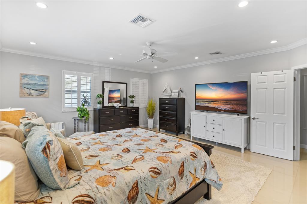 1650 Northeast 27th Avenue Pompano Beach, FL 33062 - Photo 46 of 90 a bedroom with a bed and a flat screen tv