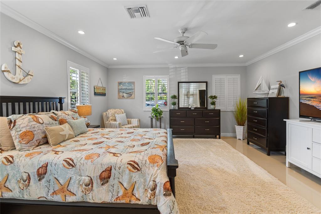 1650 Northeast 27th Avenue Pompano Beach, FL 33062 - Photo 47 of 90 a bedroom with double bed and a flat tv screen on dresser