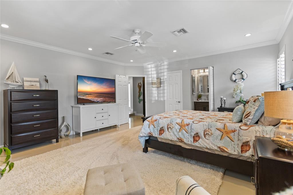 1650 Northeast 27th Avenue Pompano Beach, FL 33062 - Photo 48 of 90 a bedroom with a bed and a flat screen tv