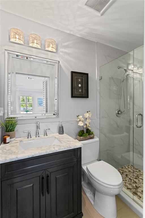 1650 Northeast 27th Avenue Pompano Beach, FL 33062 - Photo 50 of 90 a bathroom with a sink a toilet and shower