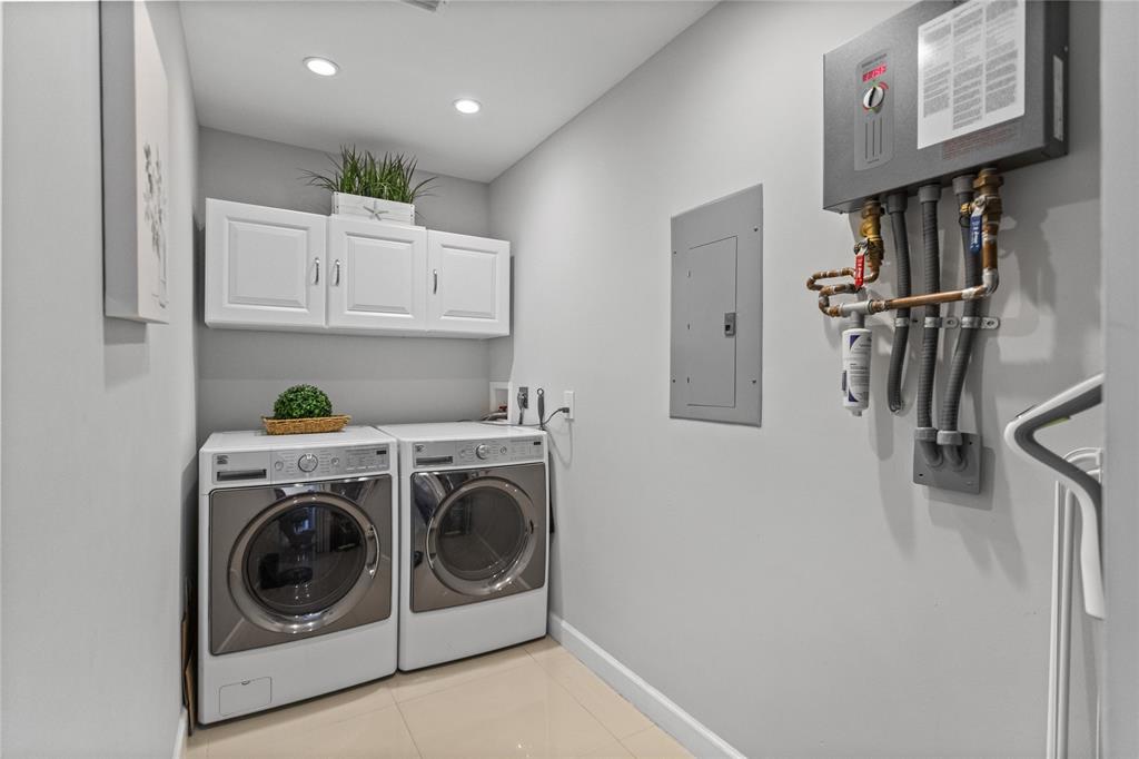 1650 Northeast 27th Avenue Pompano Beach, FL 33062 - Photo 55 of 90 a view of a storage and utility room with washer and dryer